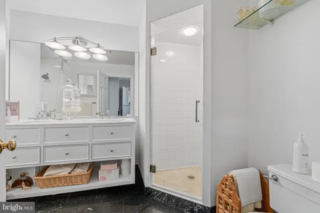 a bathroom with a sink mirror and a shower