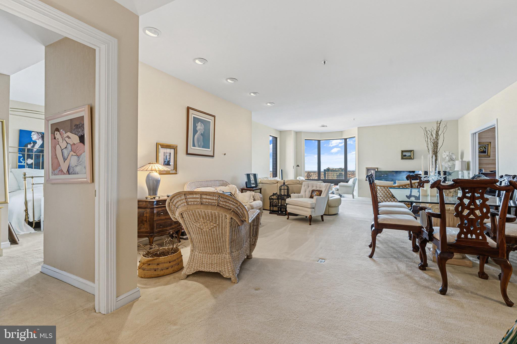 10 East Lee Street, Unit 2008 Baltimore, MD 21202 - Photo 4 of 23 a living room with furniture and a dining table with chairs