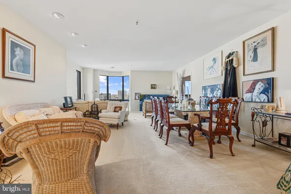 a living room with lots of furniture and painting on the wall