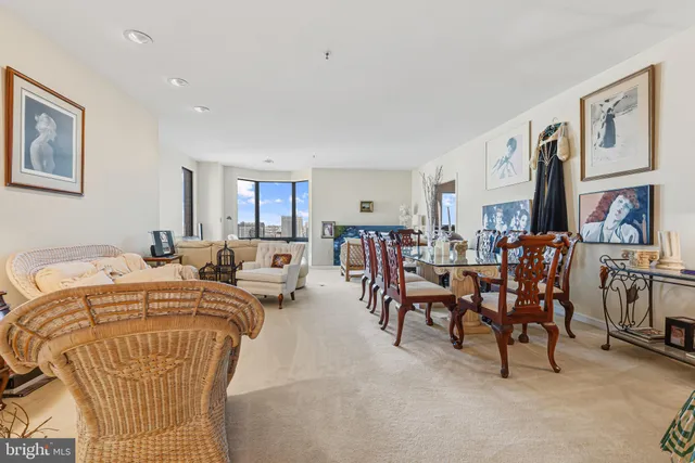 a living room with lots of furniture and painting on the wall