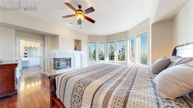 a bedroom with a large bed and a fireplace