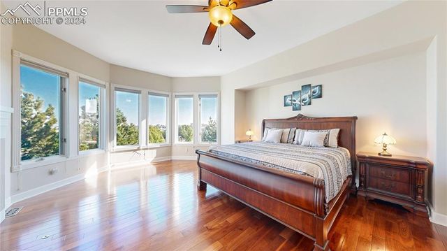 a bedroom with a large bed and a large window