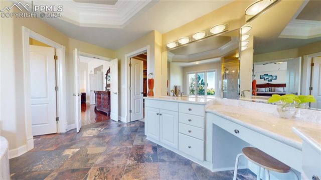 a spacious bathroom with a granite countertop sink mirror and shower