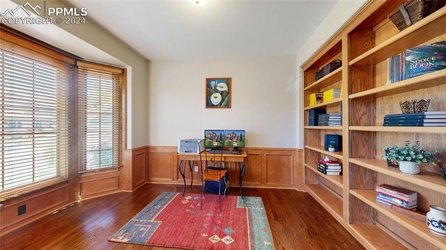a living room with furniture and a book shelf