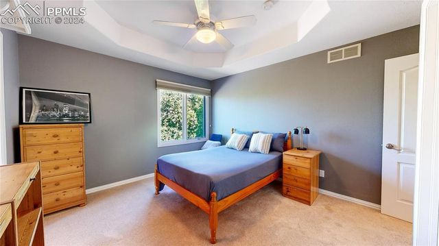 a bedroom with a bed and a dresser in it