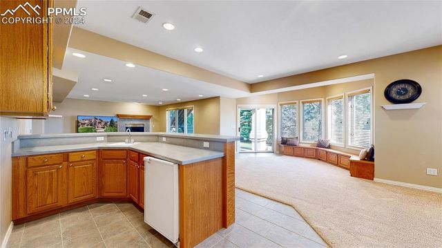 a large kitchen with stainless steel appliances granite countertop a sink and cabinets