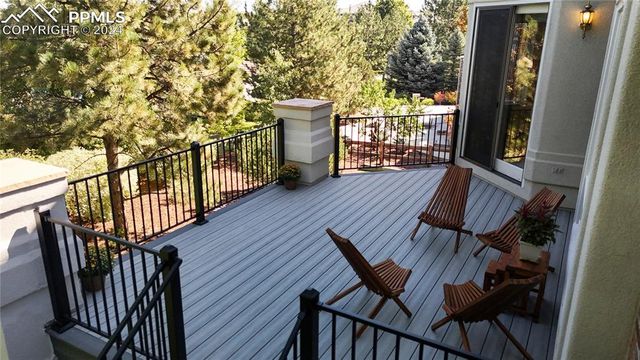 a view of balcony with wooden floor and outdoor seating
