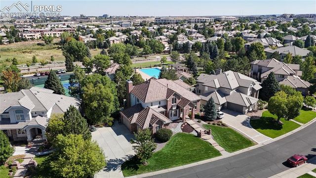 an aerial view of multiple houses with yard