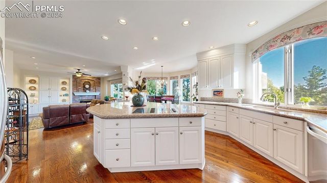 a large white kitchen with a large window