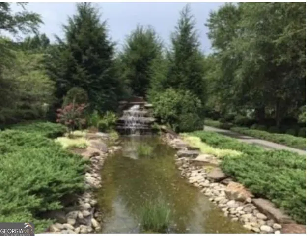 a view of a lake with trees all around