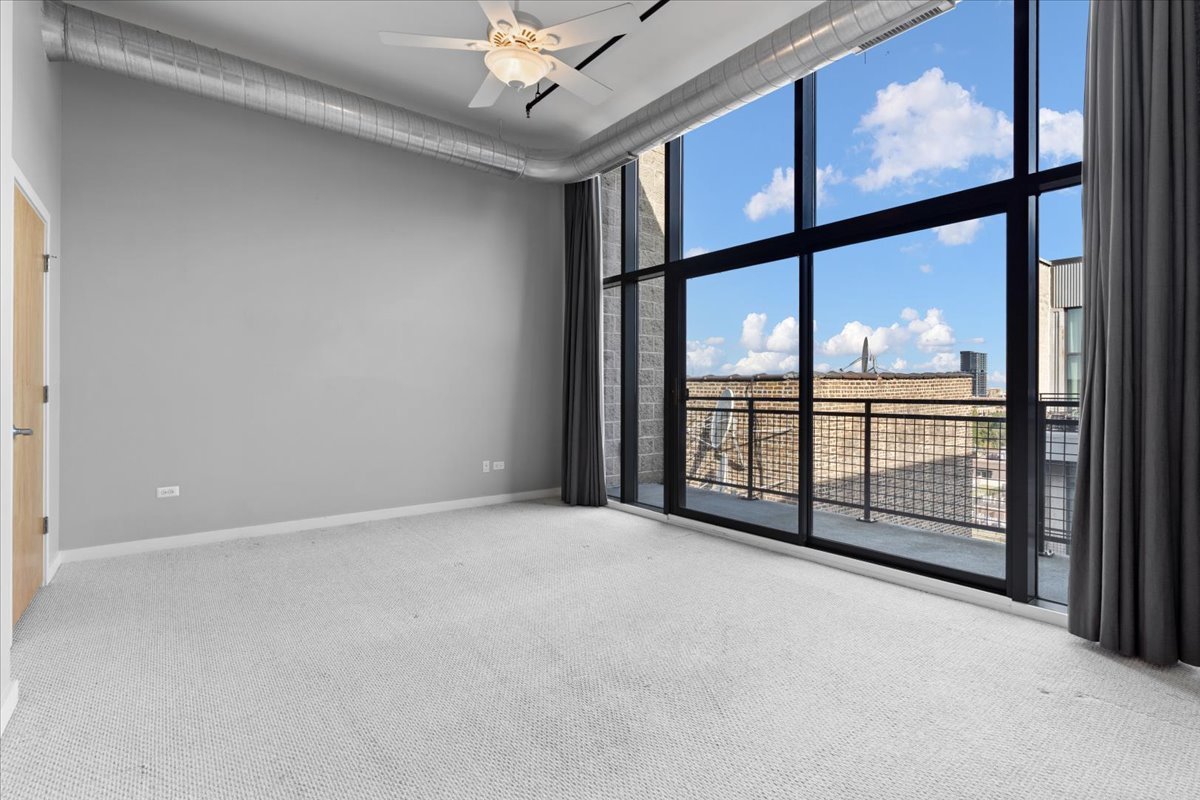 1224 West Van Buren Street, Unit 809 Chicago, IL 60607 - Photo 11 of 25 a view of an empty room with windows