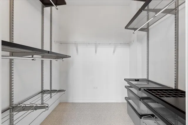 a bathroom with a sink double vanity granite tub shower and a mirror