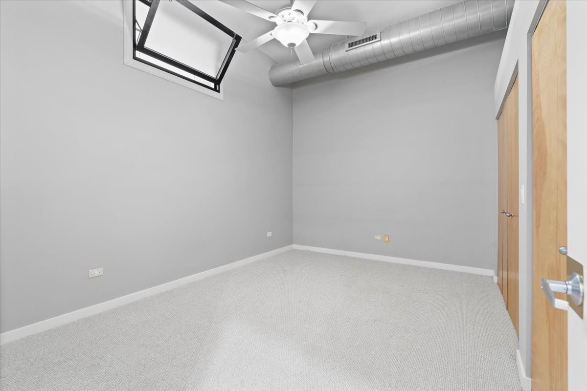 1224 West Van Buren Street, Unit 809 Chicago, IL 60607 - Photo 19 of 25 a view of an empty room with a window