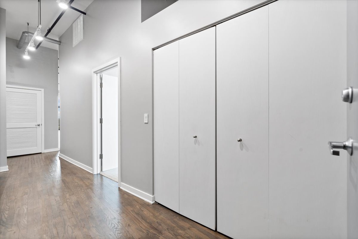 1224 West Van Buren Street, Unit 809 Chicago, IL 60607 - Photo 24 of 25 a view of a hallway with wooden floor