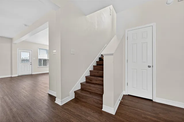 a view of an entryway with wooden floor