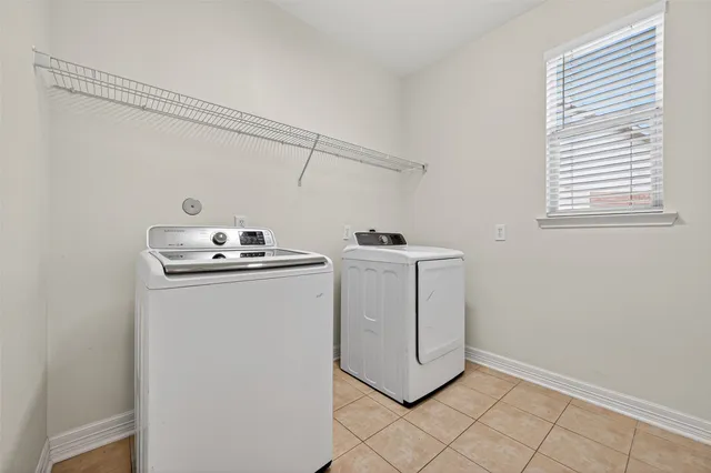 a utility room with closet dryer and washer