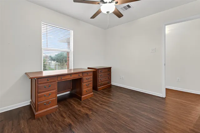 a room with a desk and a window