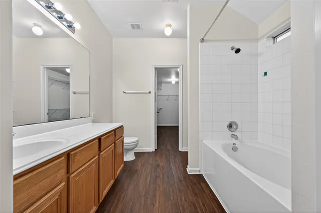 a bathroom with a bathtub a sink and a large mirror