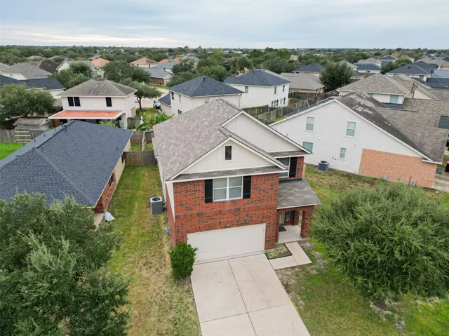 an aerial view of a house with a yard
