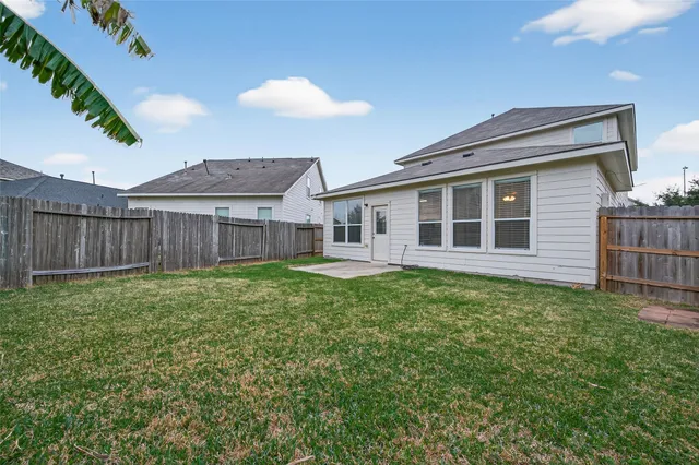 a view of a house with a backyard