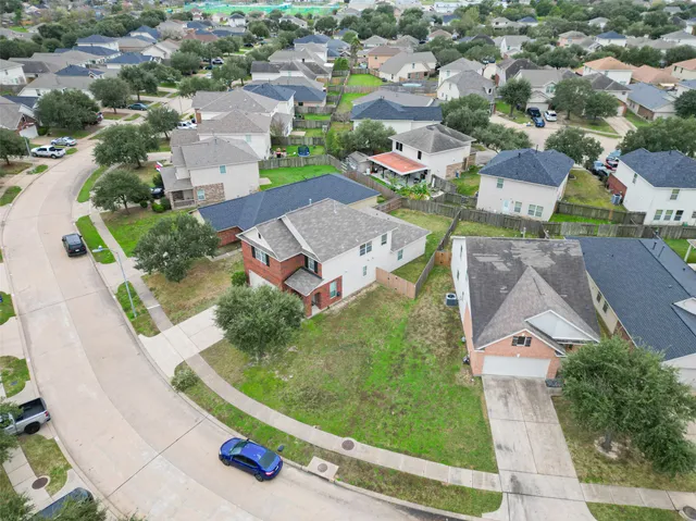 an aerial view of residential houses with outdoor space