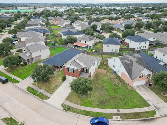 an aerial view of residential houses with outdoor space