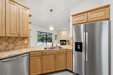 a kitchen with granite countertop a sink stainless steel appliances and cabinets