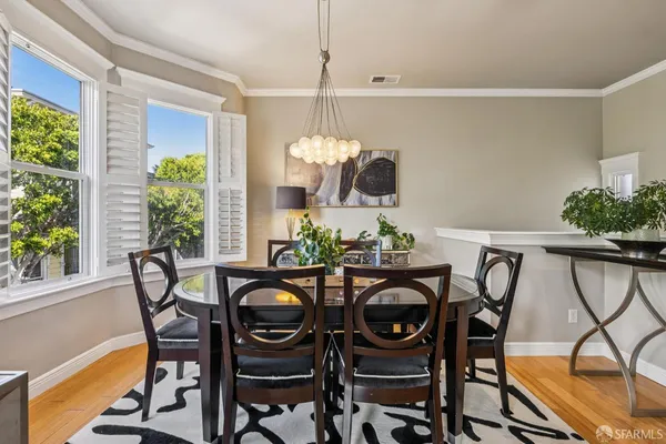 a dining room with furniture a fireplace and wooden floor