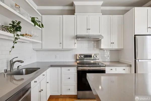a kitchen with stainless steel appliances granite countertop a sink and wooden cabinets