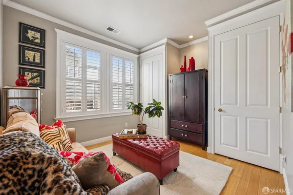 a bedroom with a bed and a potted plant
