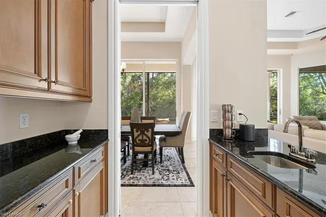 a kitchen with granite countertop a sink stove and cabinets