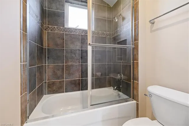 a white bath tub and a toilet