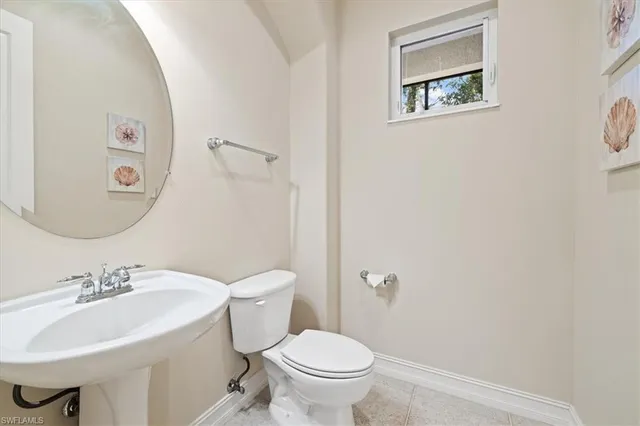 a bathroom with a sink mirror and toilet