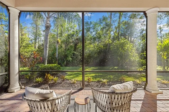 a view of a chair and tables in the balcony