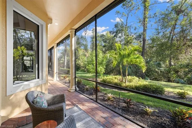 a living room with couch and trees in the front