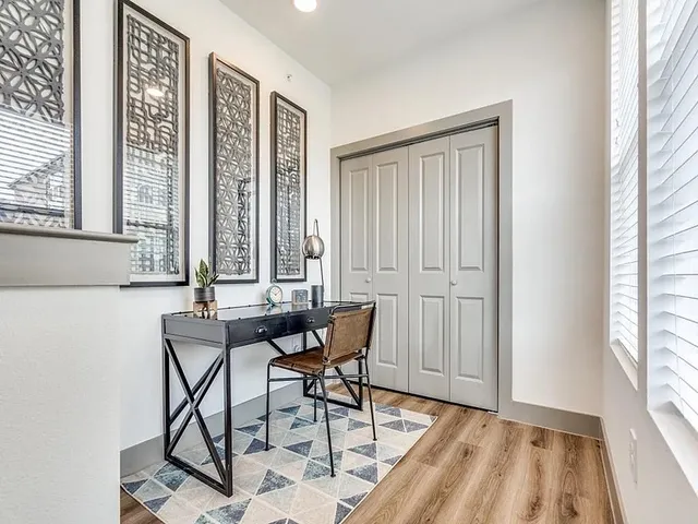 a view of a room that has a table and chair in it