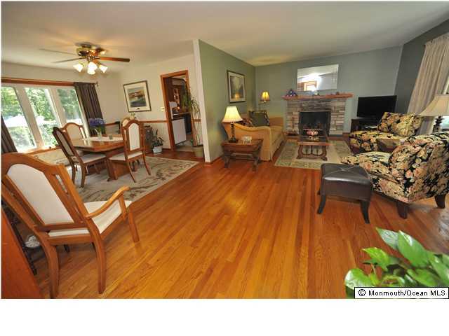 108 Manaqua Road Freehold, NJ 07728 - Photo 3 of 3 a living room with furniture and a wooden floor