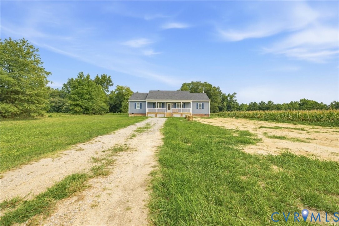6019 Otterdam Road Waverly, VA 23890 - Photo 2 of 26 Blue siding exterior with a covered front porch, w