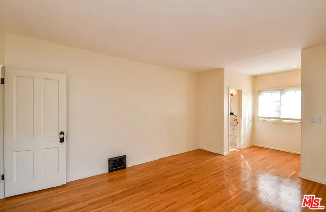a view of an empty room and wooden floor