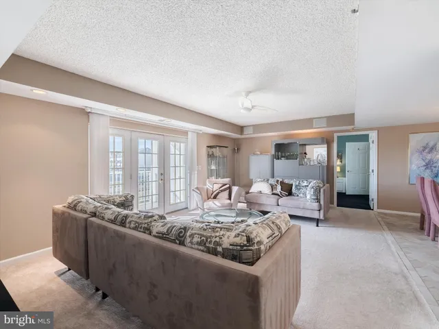 a living room with furniture and large windows