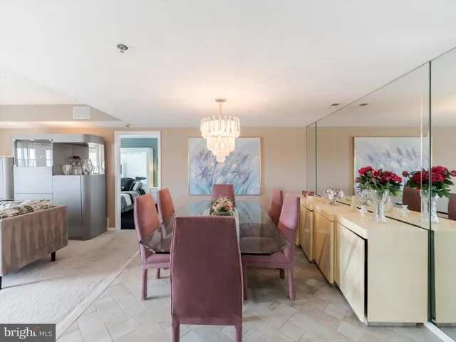 a view of a dining room with furniture and a chandelier