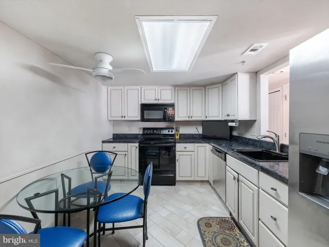 a kitchen with a sink cabinets and window