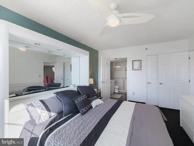 a large bedroom with a bed and a chandelier