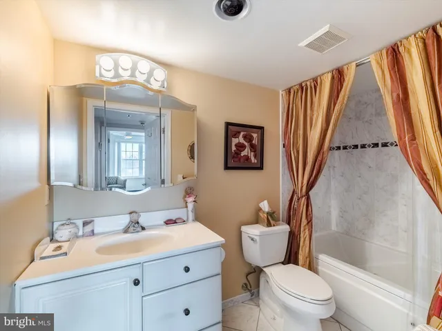 a bathroom with a sink a toilet a mirror and shower