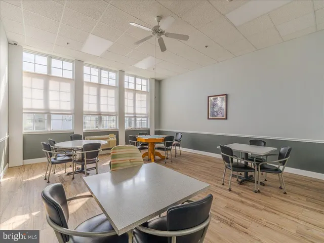 a dining room with wooden floor and a chandelier