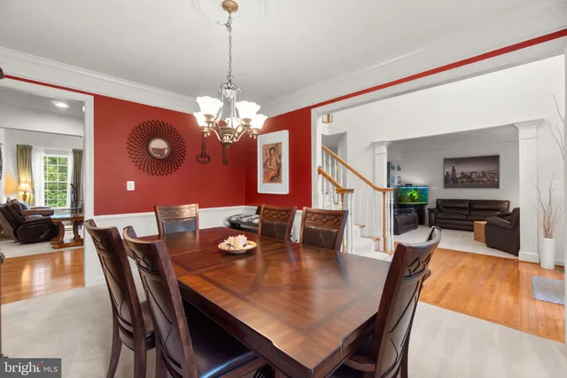 a dining room with furniture a rug and wooden floor