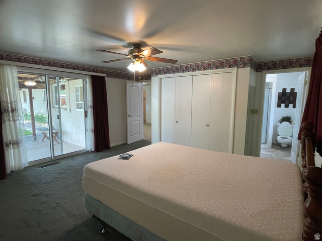 438 East Main Street Elsinore, UT 84724 - Photo 27 of 43 Primary bedroom with private bath and sliding glass doors opening to an exterior patio, a white bi-fold closet, and a doorway revealing a bathroom.