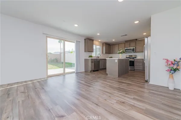 a view of kitchen with wooden floor and electronic appliances