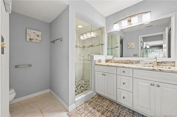 a bathroom with a sink and mirror with toilet