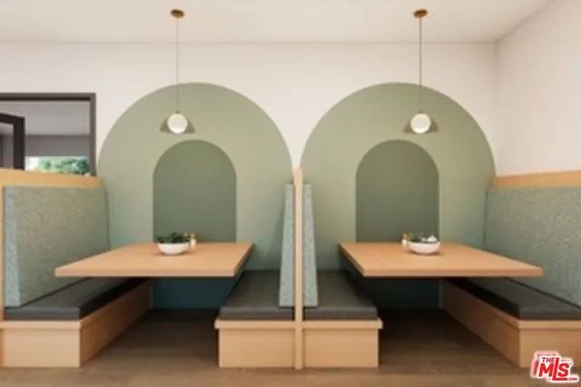 a living room with couches a mirror and a table